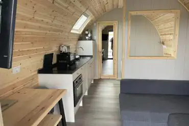 Mega ensuite glamping pod at Harbour Lights kitchen and lounge area with TV