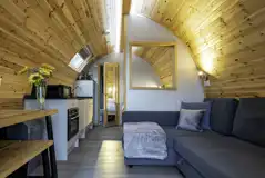 Mega glamping pod interior with a double bed and double sofa bed