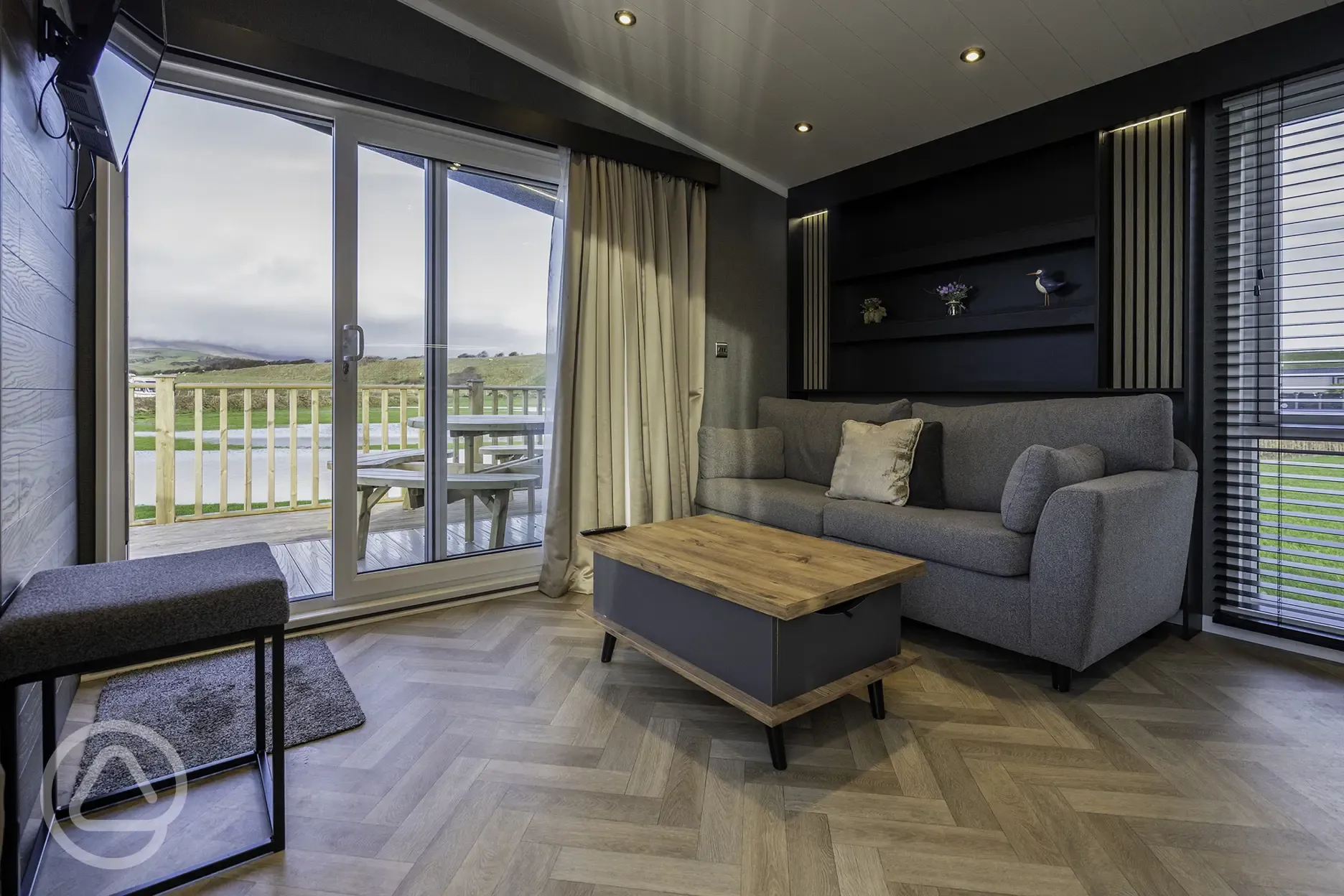 Glamping S-pod living area with sofa and TV