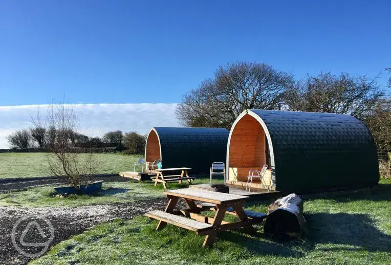 Camping pods with small decking and outdoor furniture