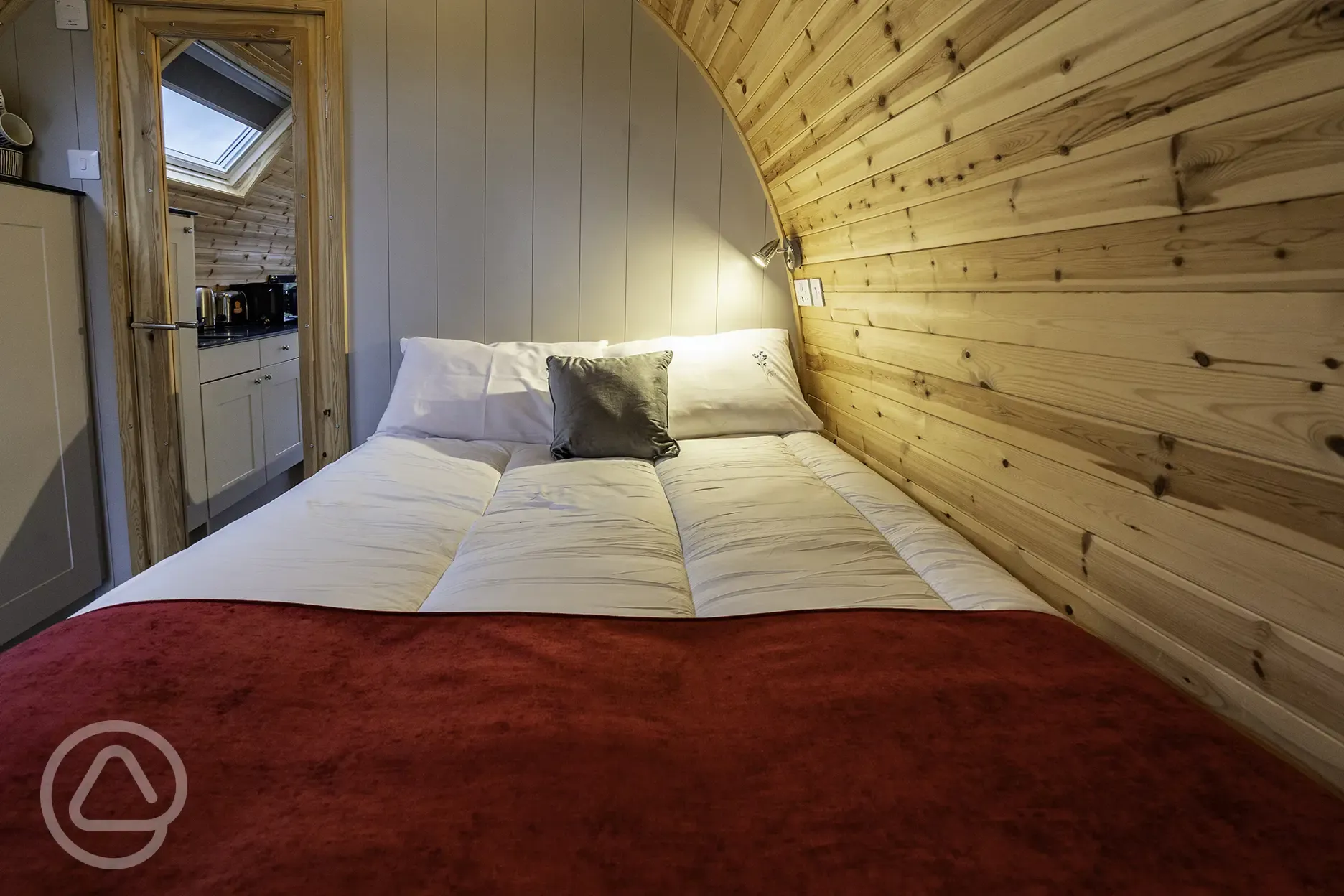 Mega glamping pod interior with a double bed