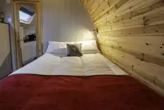 Mega glamping pod interior with a double bed