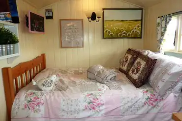 Bed inside the Shepherds Hut at The Buteland Stop
