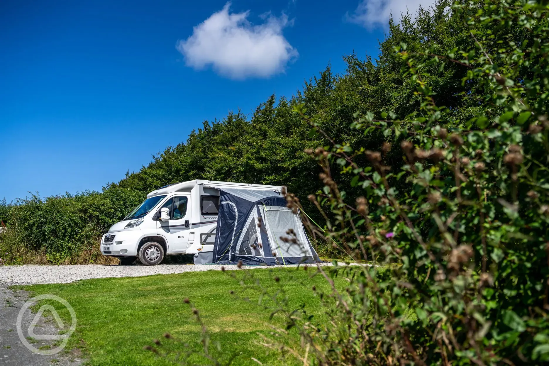 Fully serviced hardstanding pitch with grass area