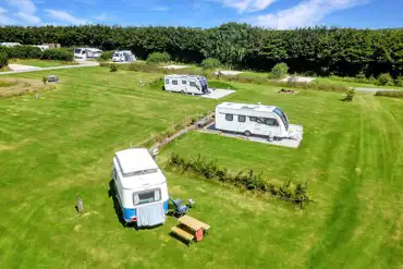 Caravans on electric grass pitches at Hallsdown Farm Touring Park
