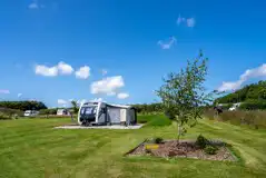 Fully serviced hardstanding pitch with gravel and grass