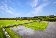 Hardstanding pitches with parking on the grass