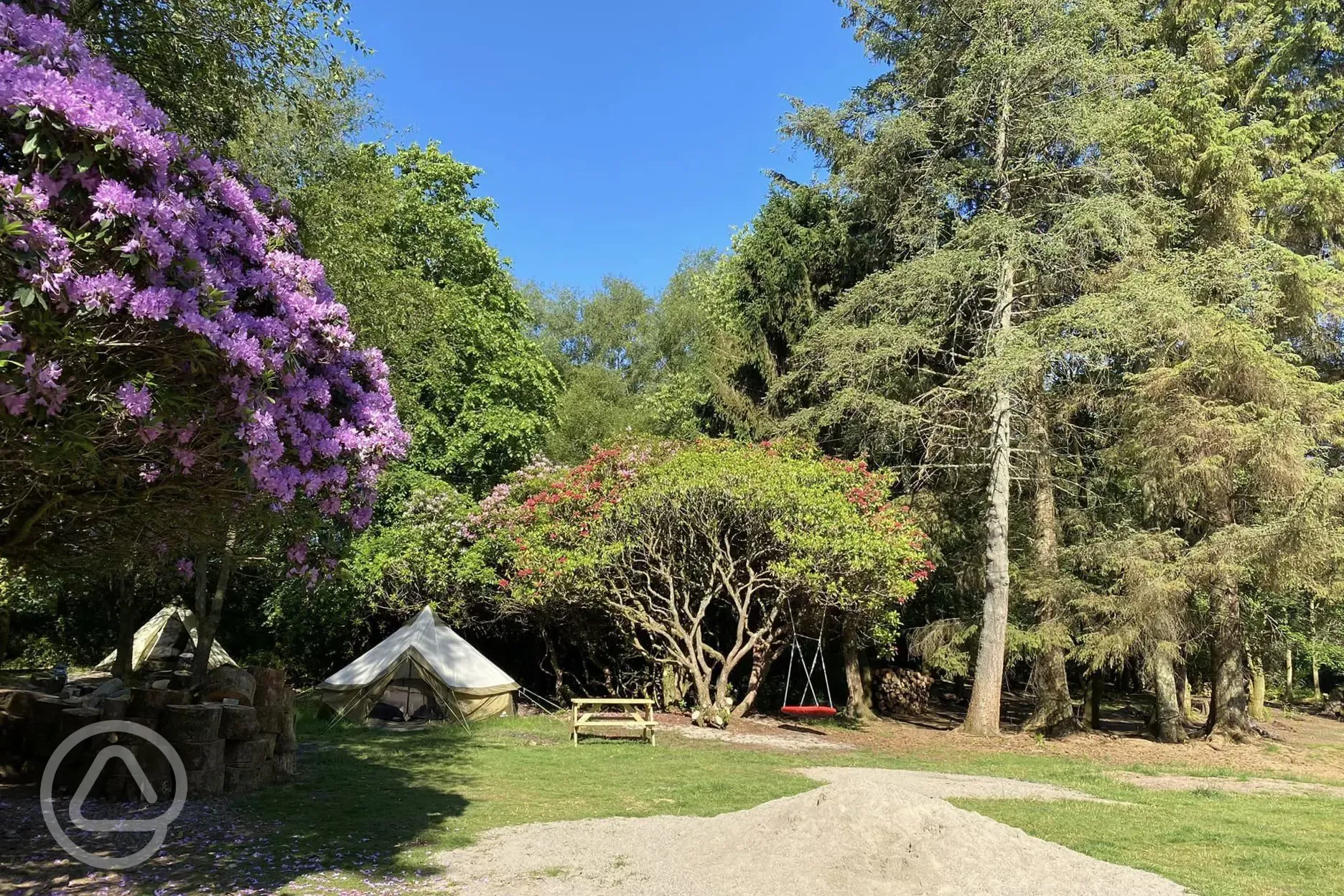 Safari bell tents at West Highland Way next to a swing and picnic benches