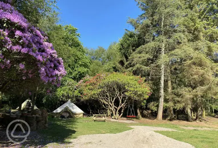 Safari bell tents at West Highland Way next to a swing and picnic benches