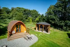 Bunny glamping pod with outdoor seating and a sheltered hot tub