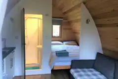 Ensuite glamping pod - interior with a double bed and sofa bed