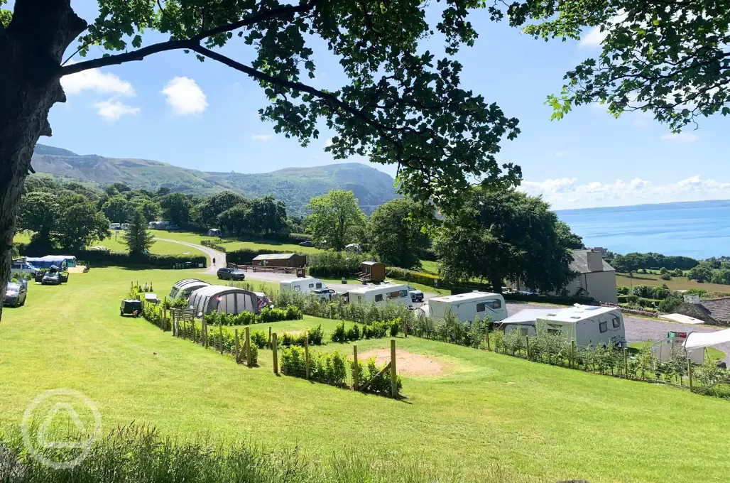 Electric grass and gravel pitches overlooking Penmaenmawr Beach