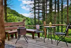 Cosy woodland cabin terrace with outdoor seating Cosy woodland cabin terrace with outdoor seating