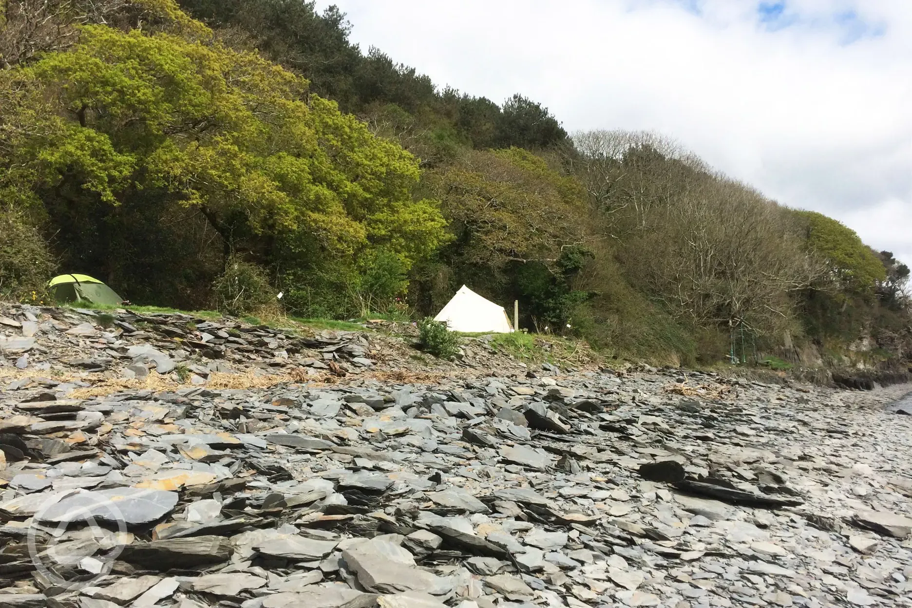 A view of Smugglers Cove Camping pitches from the water