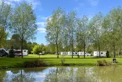 Electric grass touring pitches close to the water's edge