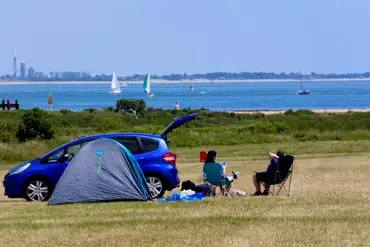 Non electric grass tent pitches at Lepe Beach Campsite overlooking Lepe Beach