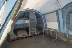 Ready tent interior with camp beds, chairs and a table