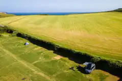 Aerial of the non electric grass pitches by the coast