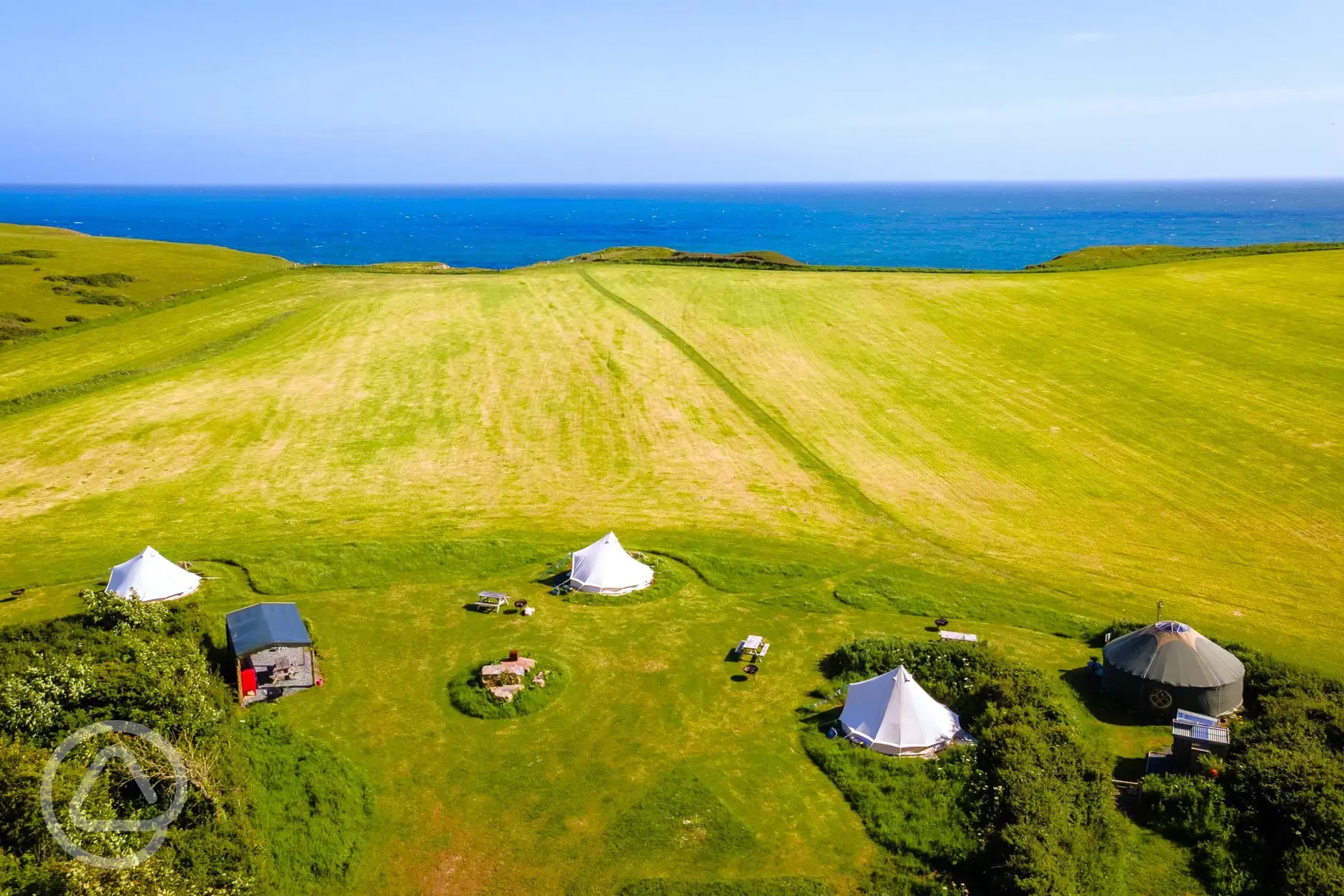 Aerial of Becks Bay Camping and Glamping with coastal views