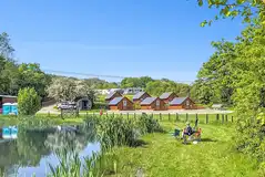 Glamping lodges around the onsite fishing pool (extra cost) at Brook House Farm