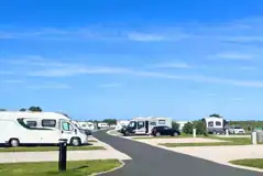 Fully serviced hardstanding pitches with grass areas between