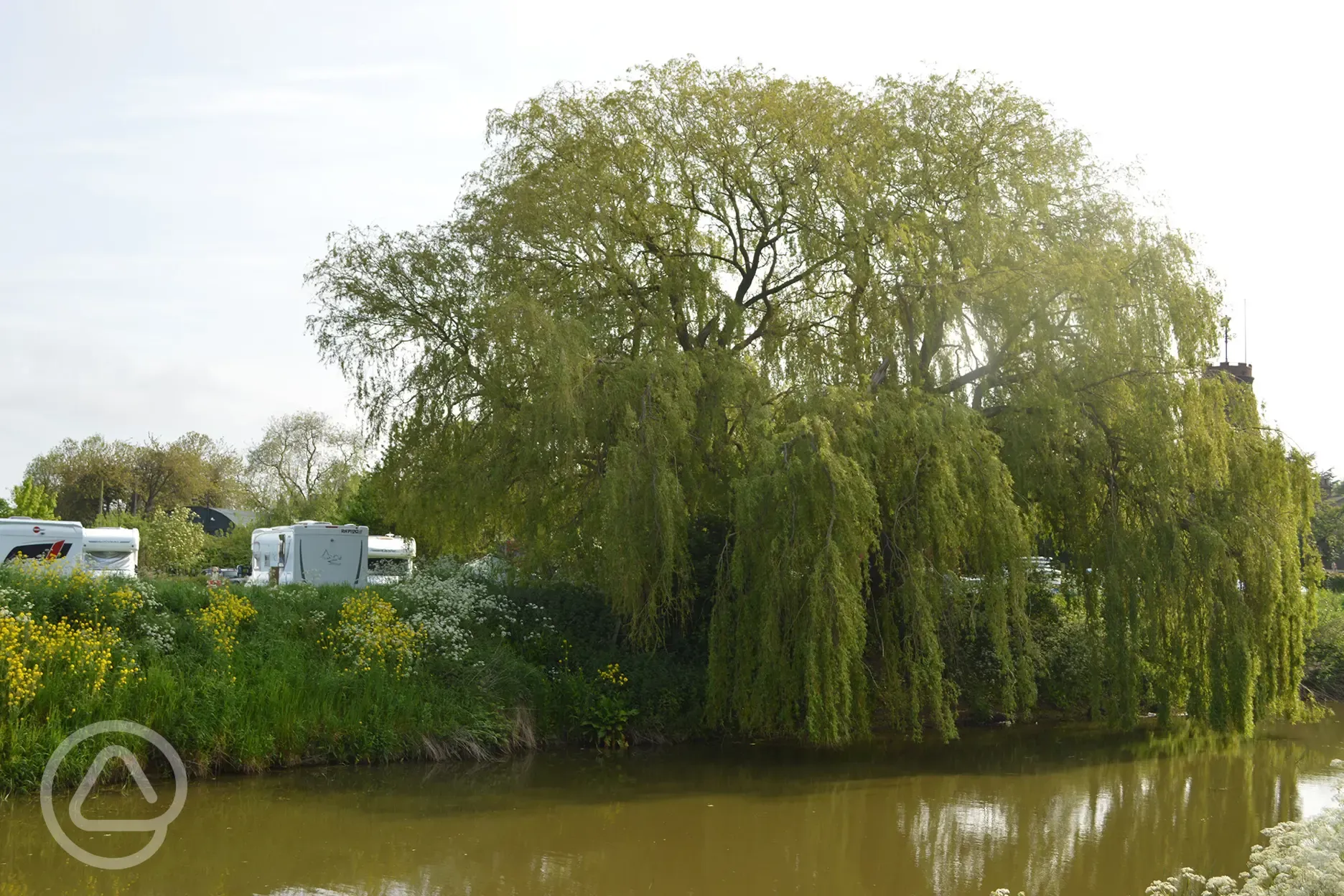 Caravan pitches by the river Bateman's Brewery