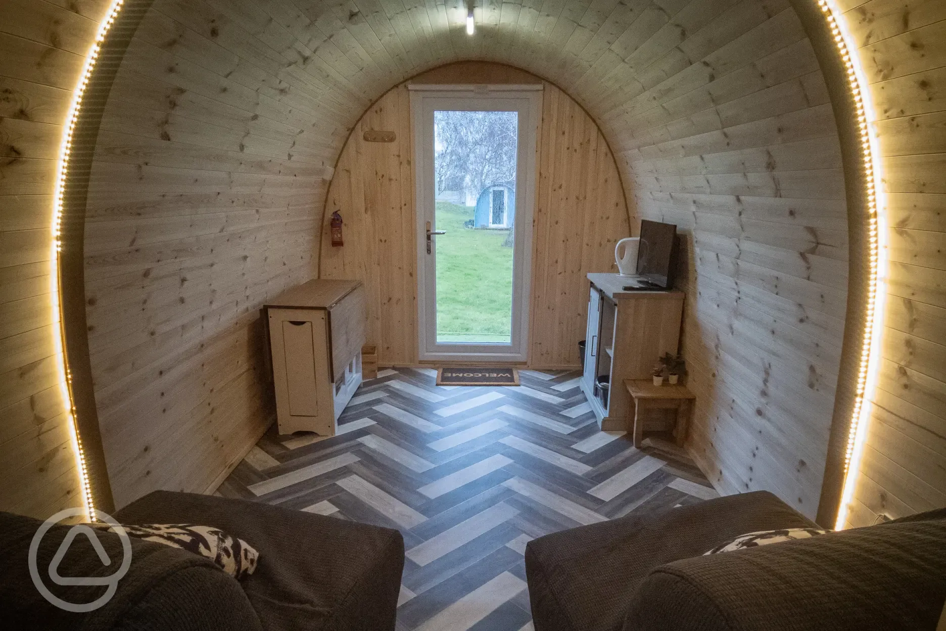 Family camping pod interior with two foldaway beds (bring own bedding)