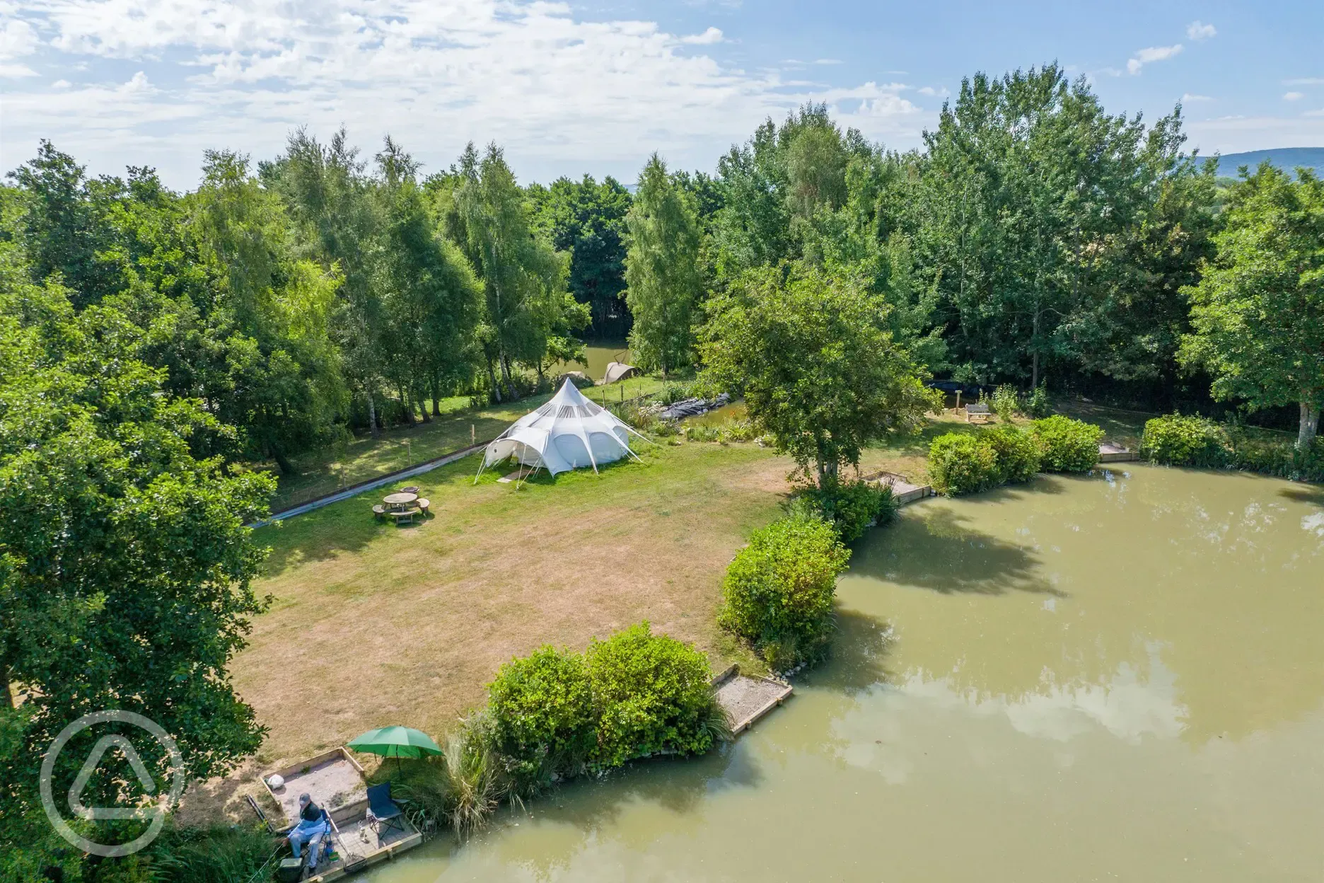 Aerial of a bell tent next to lake