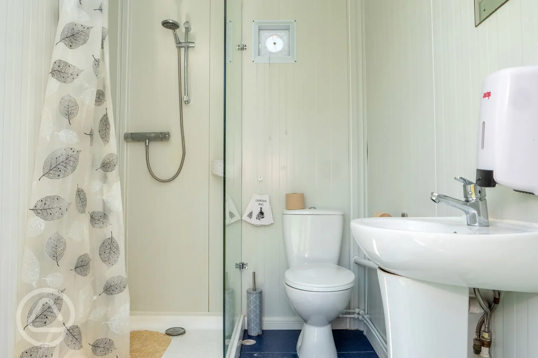 Wash room with a toilet and shower