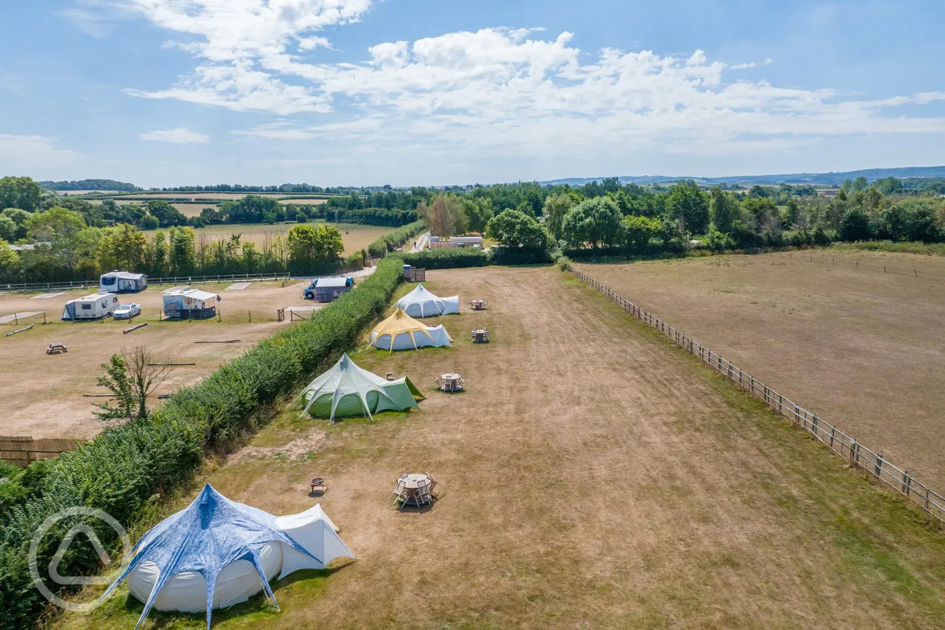 Aerial of the bell tents with countryside views