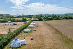 Aerial of the bell tents with countryside views