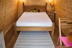Alder camping pod interior with a double bed (bring own bedding)