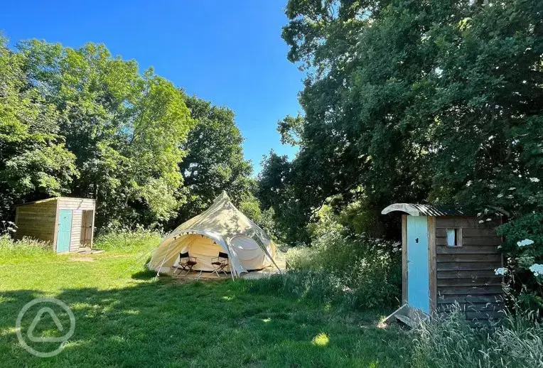 Furnished bell tent with a compost toilet