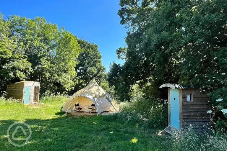 Furnished bell tent with a compost toilet