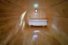 Four person camping pod interior with four single mattresses