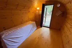 Four person camping pod interior with four single mattresses Four person camping pod interior with four single mattresses