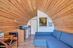 Ensuite Cosier glamping pod sofa bed and kitchen area