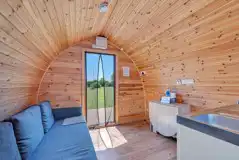 Family glamping pod interior with sofa bed