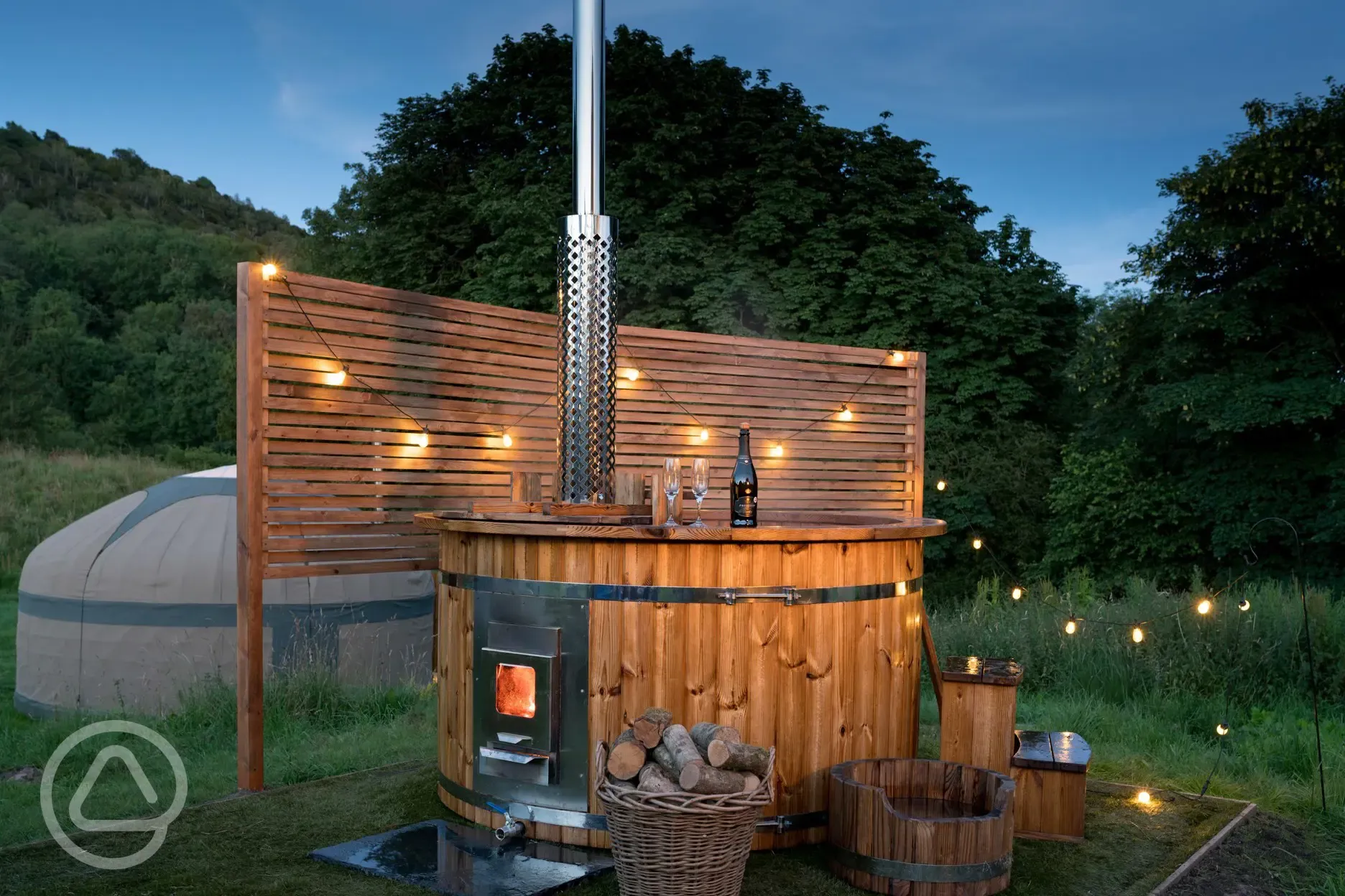 Yurt with hot tub and lighting at night