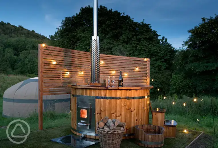 Yurt with hot tub and lighting at night