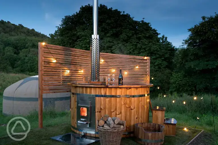 Yurt with hot tub and lighting at night
