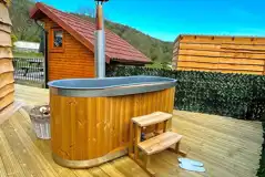 Mini lodge pod with hot tub on private decking area Mini lodge pod with hot tub on private decking area