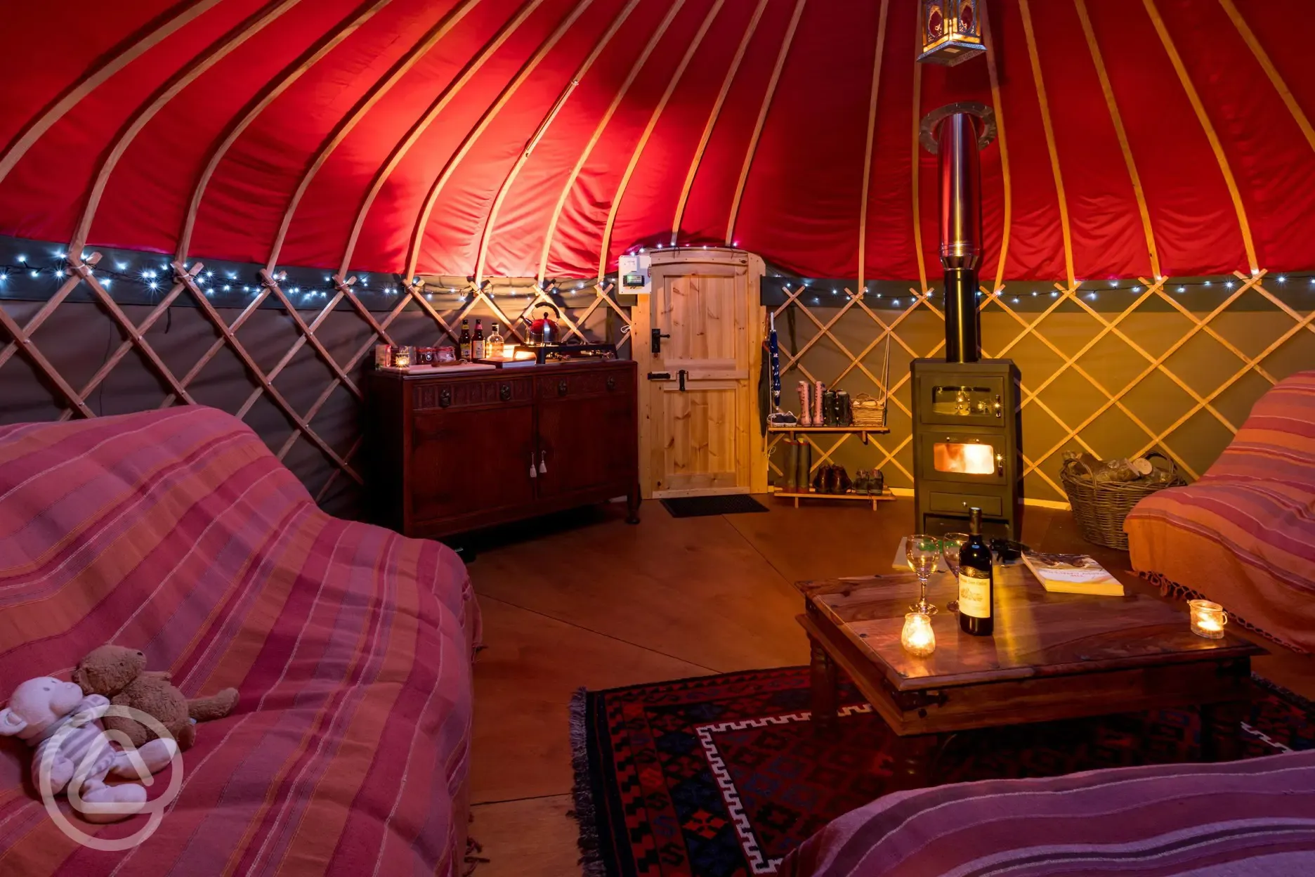 Yurt interior with wood burner, oven, hot place, gas hob, cutlery and crockery