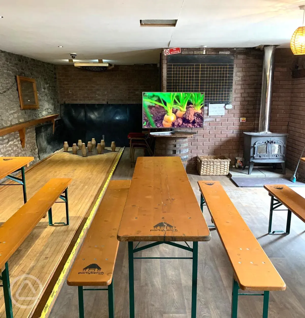 Seating, TV and skittles alley in the pub