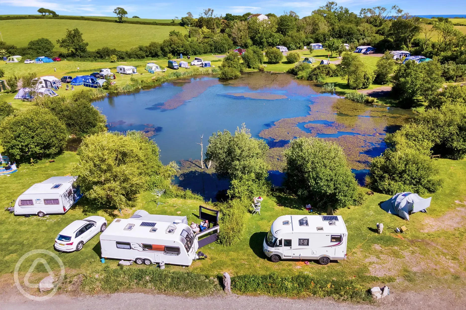 Aerial of electric grass pitches at Carn Springs overlooking the lake