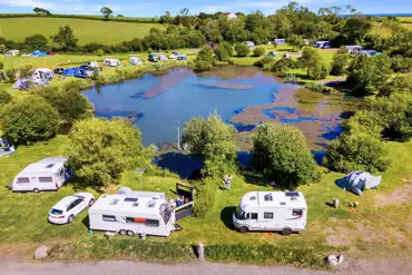 Aerial of electric grass pitches at Carn Springs overlooking the lake