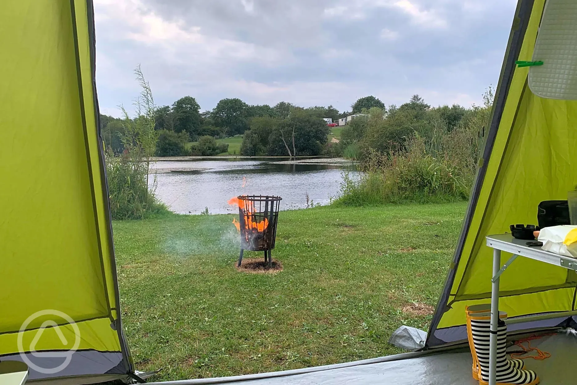Views from the electric lake view grass pitches with fire pit