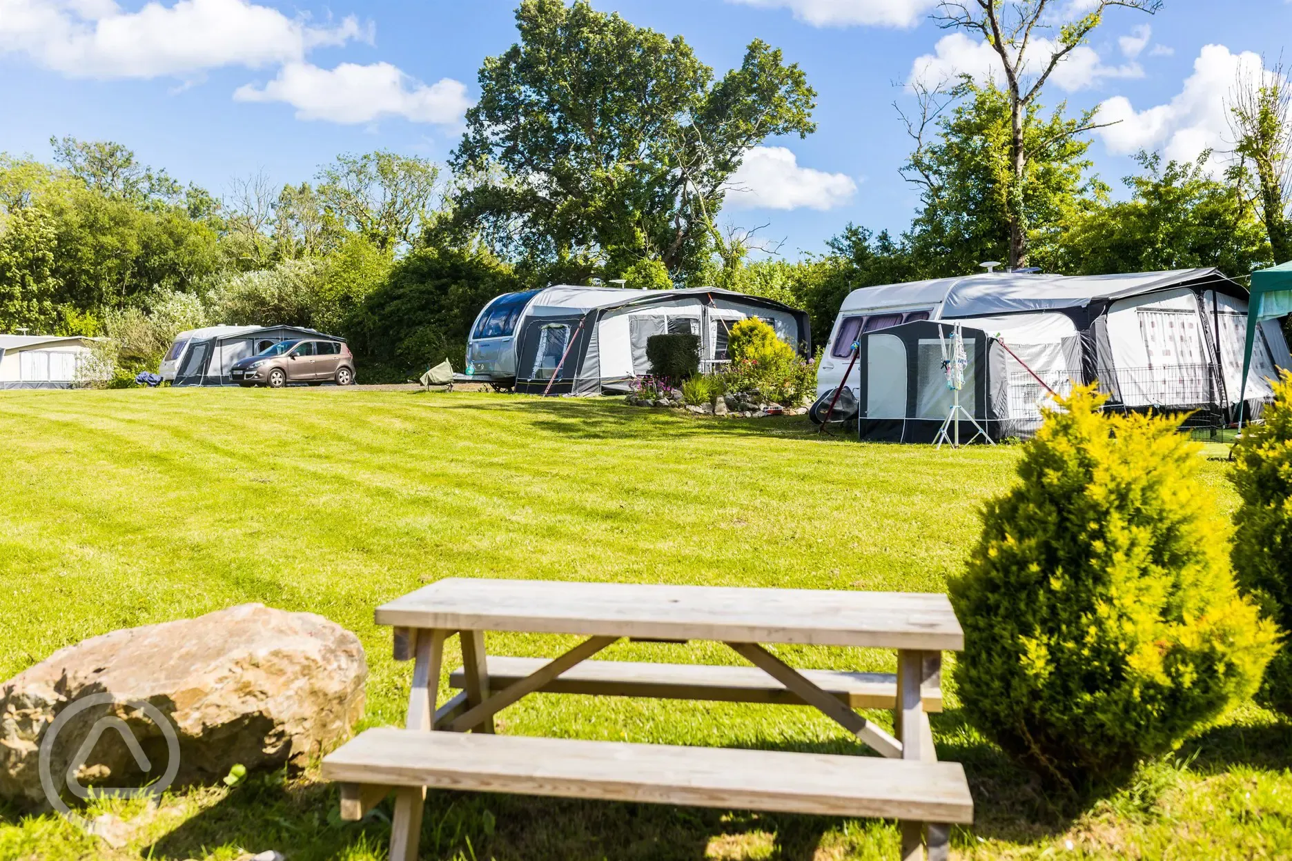 Caravans on electric grass pitches with awnings