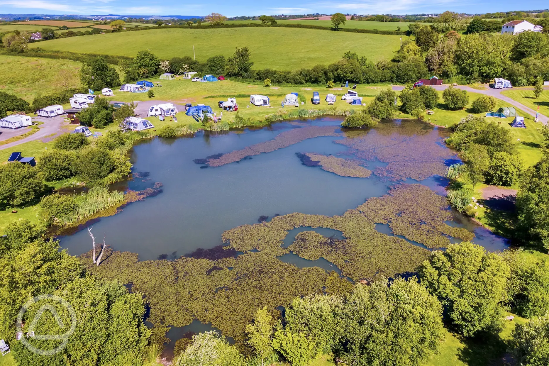 Aerial of electric lake view grass pitches at Carn Springs