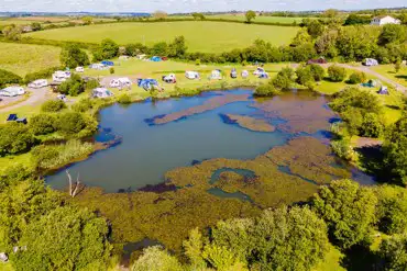 Aerial of electric lake view grass pitches